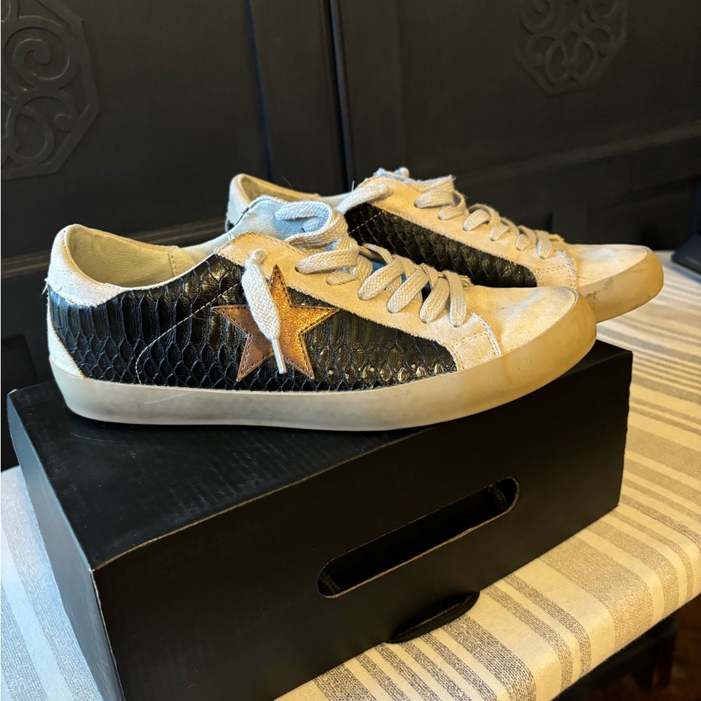 Shu Shop black and gold star tennis shoes in excellent condition